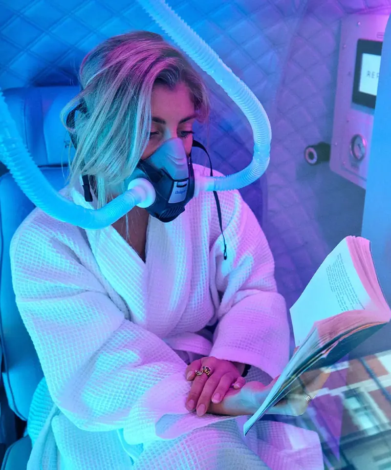 Patient using the chamber for an oxygen therapy session
